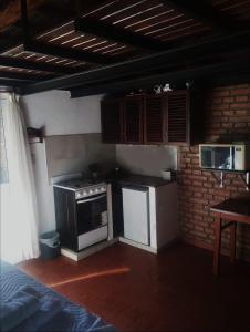 a kitchen with a stove top oven in a room at Laitale Uturu in San Salvador de Jujuy