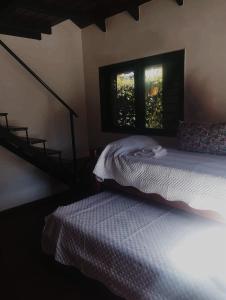 a bedroom with a bed and a window at Laitale Uturu in San Salvador de Jujuy +4 photos