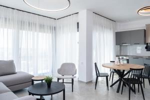 a living room with a couch and a table at Olympiada Residential Complex & Villas in Ofrínion