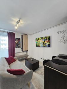 a living room with a couch and a table at The Solstice Studio Apartment in Cluj-Napoca
