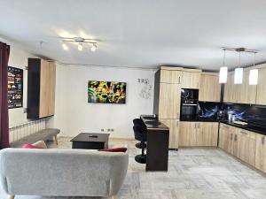 a living room with a couch and a table at The Solstice Studio Apartment in Cluj-Napoca