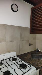 a stove top in a kitchen with a sink at Laitale Uturu in San Salvador de Jujuy