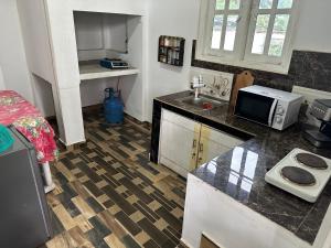 a kitchen with a sink and a counter top at Aththanayaka walawwa in Polgolla