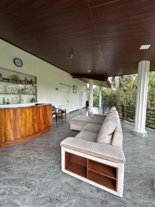 a living room with two couches and a counter at Aththanayaka walawwa in Polgolla