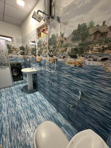 a bathroom with a mural of a river at Aththanayaka walawwa in Polgolla