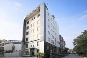 a tall white building with a sign on it at Hotel Amber Palace in Gurgaon