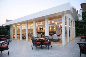 a patio with tables and chairs in a restaurant at Hotel Amber Palace in Gurgaon
