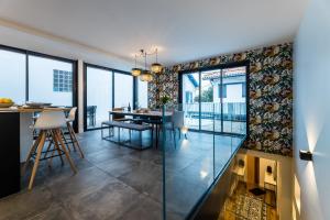 a dining room and living room with a glass wall at BLOOMY - Villa Biarritz in Biarritz