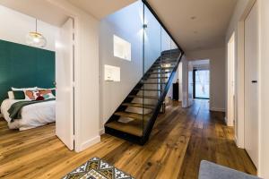 a bedroom with a staircase leading to a bed at BLOOMY - Villa Biarritz in Biarritz
