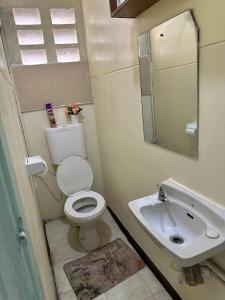 a bathroom with a toilet and a sink at Peaceful Place 1 in Nairobi +13 photos