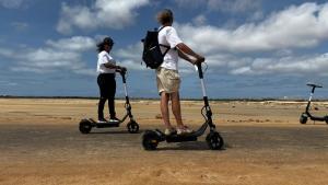 two people are riding scooters on the beach at SOL AZUL in Santa Maria