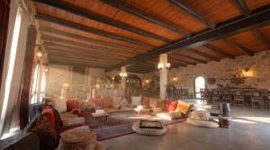 a large living room with couches and a stone wall at Golden Heights Resort in Al Ḩanī