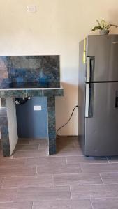 a kitchen with a counter and a refrigerator at Hostel La Suerte in Monteverde Costa Rica