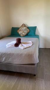 a bed with towels and a teddy bear on it at Hostel La Suerte in Monteverde Costa Rica