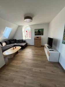 a living room with a couch and a tv at Hof Volkmann in Nordkirchen