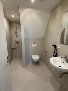 a bathroom with a shower and a toilet and a sink at Hof Volkmann in Nordkirchen +30 photos