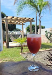 a drink in a glass sitting on a table at POUSADAGiraGarden Containers in Arroio do Silva