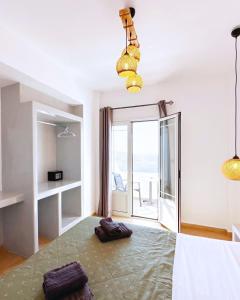 a bedroom with a bed with a view of the ocean at Hermes-Ios Rooms To Let in Ios Chora +175 photos