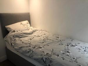 a bed with a white blanket with flowers on it at Chalet 147 South Shore Bridlington in Bessingby