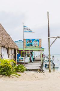 un muelle en una playa con un barco en el agua en Casa Brisa Guest House, en San Pedro 15 fotos más