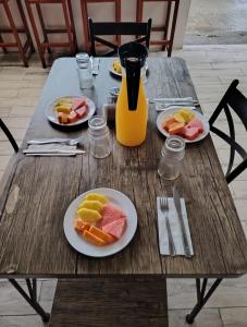 a wooden table with plates of food on it at Cabinas ensueños in Tortuguero