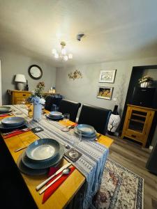 a dining room table with plates on top of it at The Milton Accommodation in Elgin