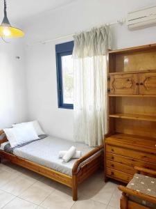 a bedroom with a bed and a window at Blue View in Livadia