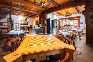 a dining room with a chessboard on a table at Formanka Hanušovice in Hanušovice