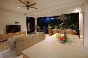 a living room with a couch and a table at Juan Villa Legian in Seminyak