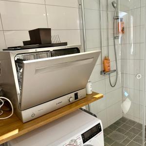 a toaster oven sitting on a counter in a kitchen at Hills Cottage Holiday Homes in Gränna +152 photos