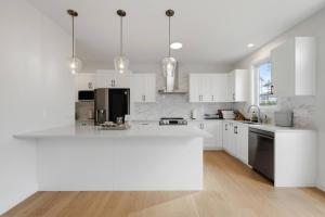 a kitchen with white cabinets and a white counter top at Quiet and Convenient Retreat in Hammonds Plains