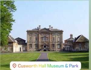 a large house with a lawn in front of it at Stay with LL in Doncaster