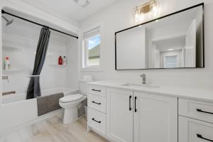 a white bathroom with a sink and a toilet at Quiet and Convenient Retreat in Hammonds Plains +34 photos