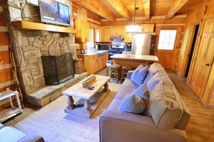 a living room with a couch and a stone fireplace at The Cove in Canton