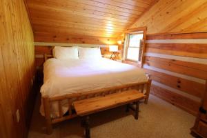 a bedroom with a bed in a log cabin at The Cove in Canton