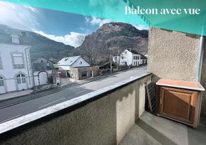 a balcony with a view of a street and mountains at Studio Anouk 4 personnes à Laruns in Laruns +7 photos