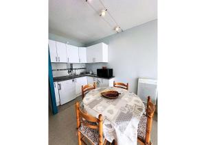 a kitchen with a table and chairs in a room at Studio Anouk 4 personnes à Laruns in Laruns