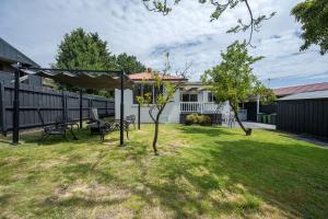 a yard with a swing set and a house at Spacious Multifunctional 5BR Retreat with Backyard in Bayswater