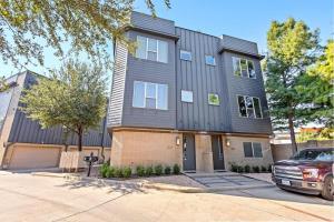 a house with a car parked in front of it at King-Sized Comfort with Rooftop Skyline Views in Dallas