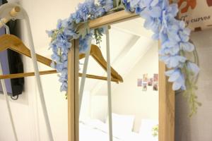 a flower garland on a mirror in a room at Bom Stay in Seoul +27 photos