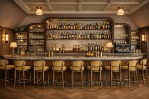 a bar with stools in a room at Florès Boutique Hotel in Zwolle
