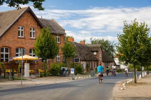 a group of people riding bikes down a street at Apartment in Putbus II in Putbus