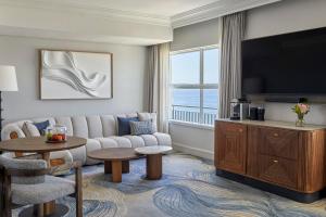a living room with a couch and a tv at InterContinental Table Bay Cape Town by IHG in Cape Town