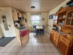 a kitchen with a table and a dining room at Friesenhus in Butjadingen
