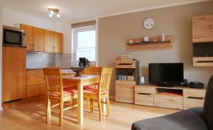 a kitchen and dining room with a table and chairs at Seegurke in Am Schwarzen Busch