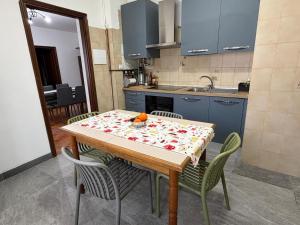 a kitchen with a table with chairs and a sink at Ziva's house apartment in Abbiategrasso in Abbiategrasso +14 photos