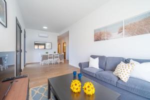 a living room with a couch and a table at Jouvacations Villa Osona in Vilafant