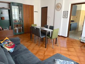 a living room with a couch and a table and chairs at Ziva's house apartment in Abbiategrasso in Abbiategrasso