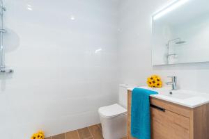 a white bathroom with a sink and a toilet at Jouvacations Villa Osona in Vilafant +39 photos