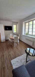 an empty living room with a table and chairs at Maestro I. in Laško
